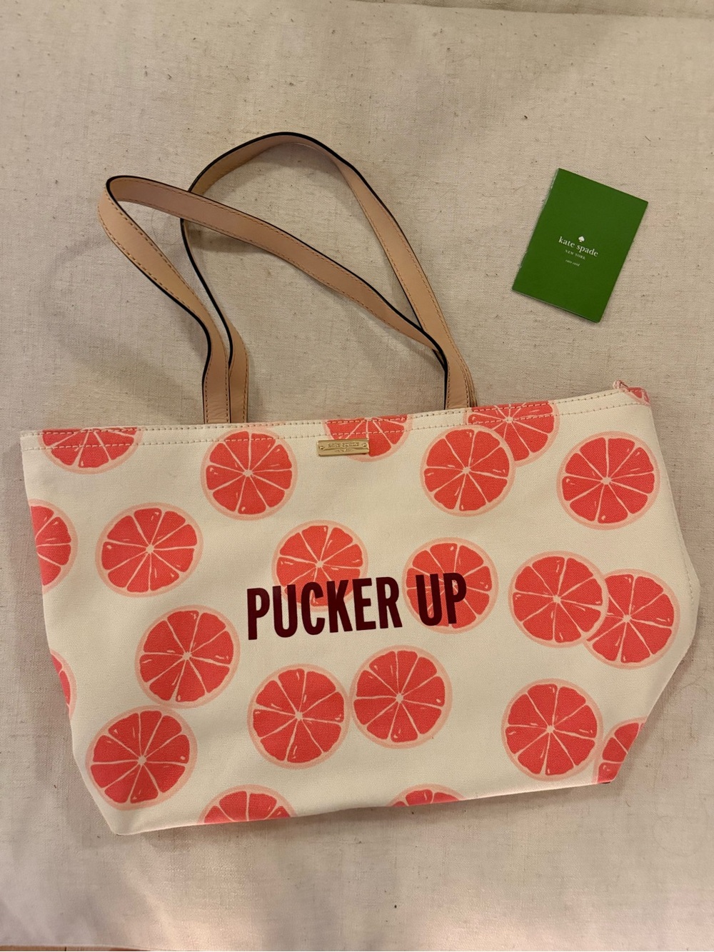 kate spade cream tote with coral citrus print and tan straps